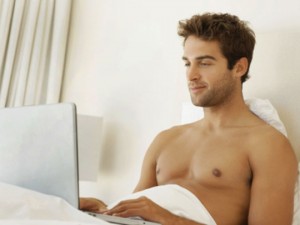 man-laptop-bed-solo-stock-med