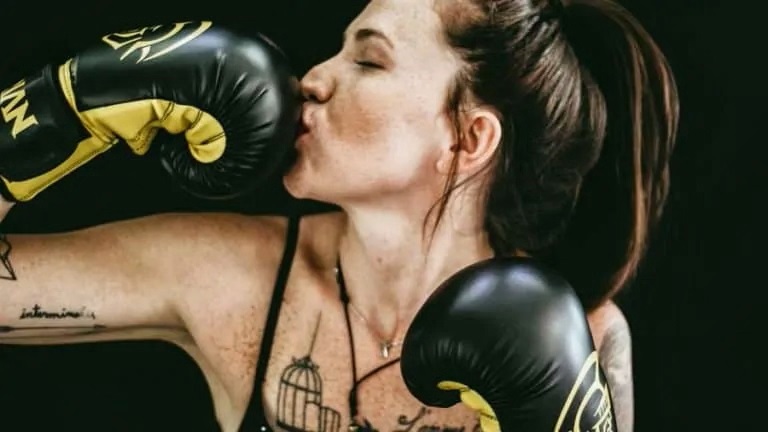 women kissing boxing glove